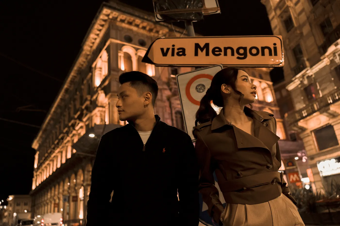 Matthew and Karin beneath the via Mengoni street sign at night