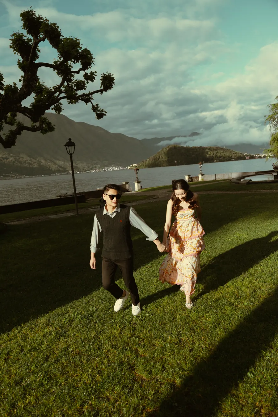 Matthew and Karin walking across a lawn by the lake